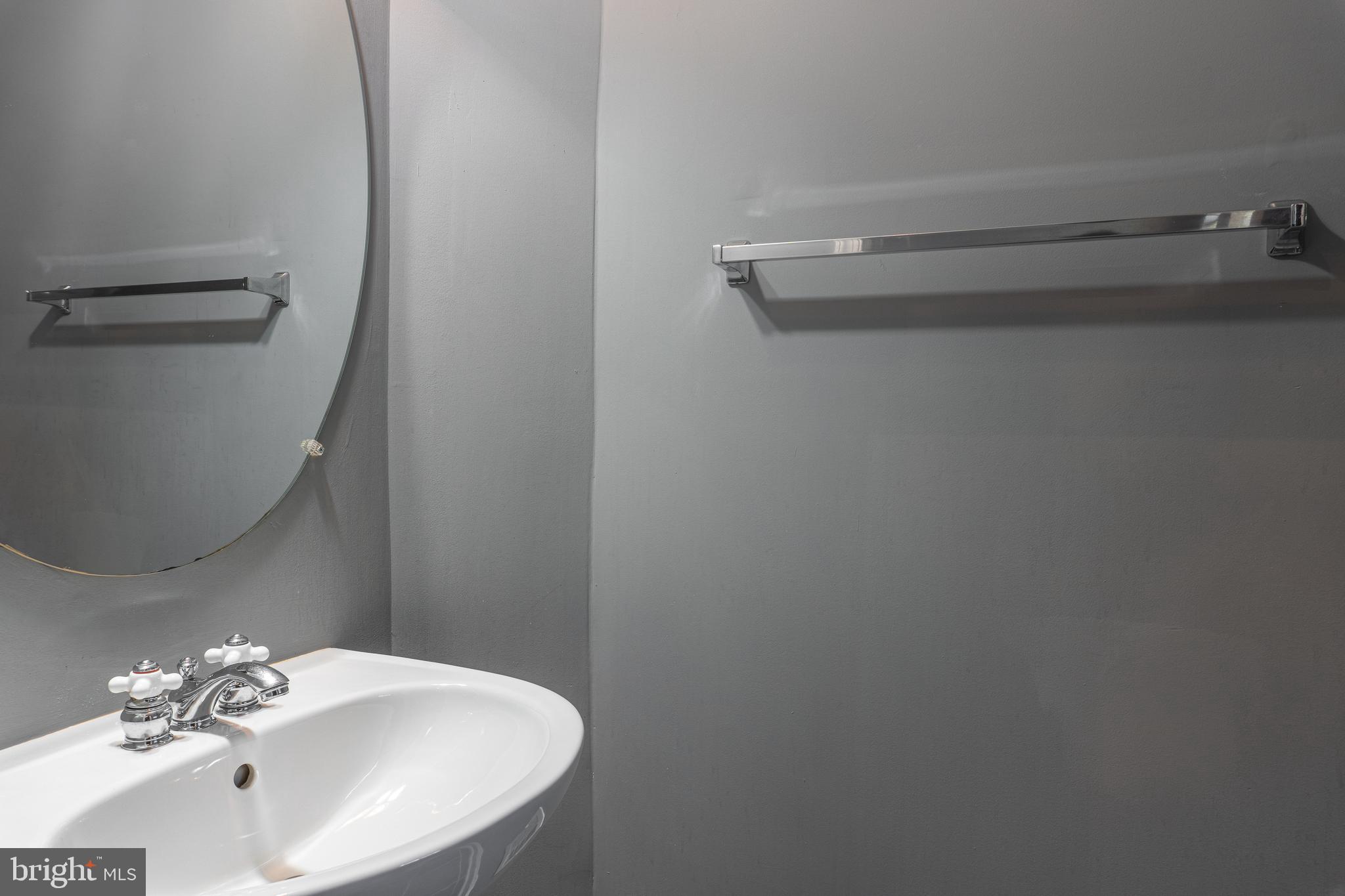 1891 Crescent Park Drive, Unit 110A Reston, VA 20190 - Photo 11 of 41 a bathroom with a sink and a mirror