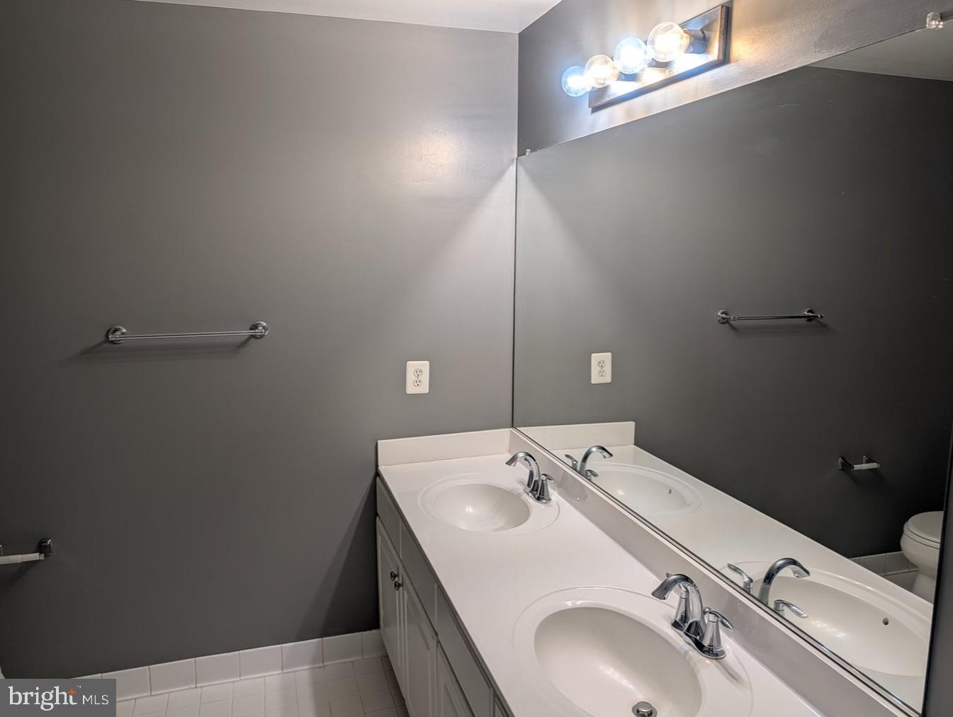 1891 Crescent Park Drive, Unit 110A Reston, VA 20190 - Photo 18 of 41 a bathroom with a sink and a mirror
