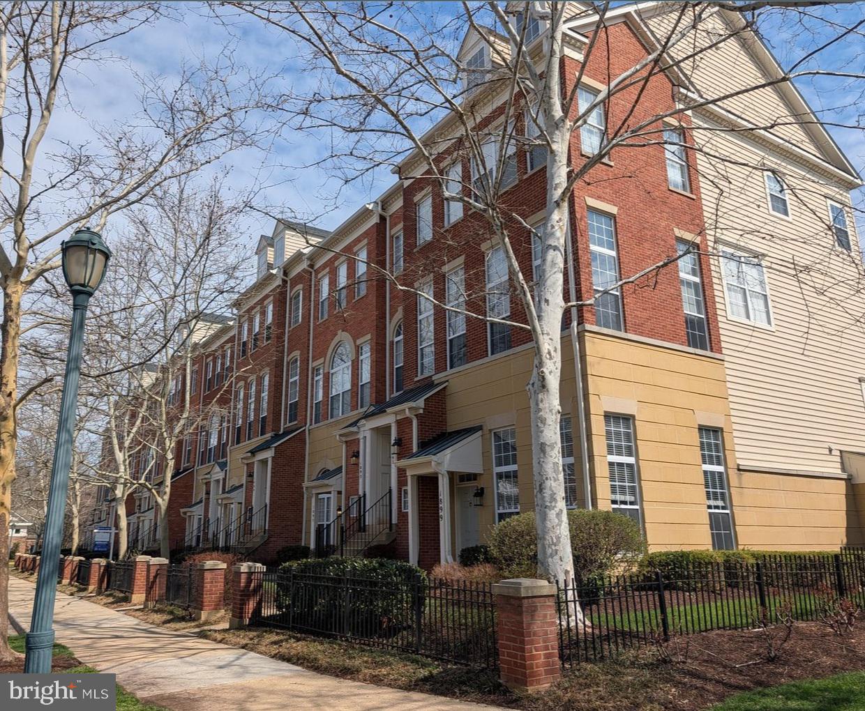 1891 Crescent Park Drive, Unit 110A Reston, VA 20190 - Photo 3 of 41 a view of a building with a yard