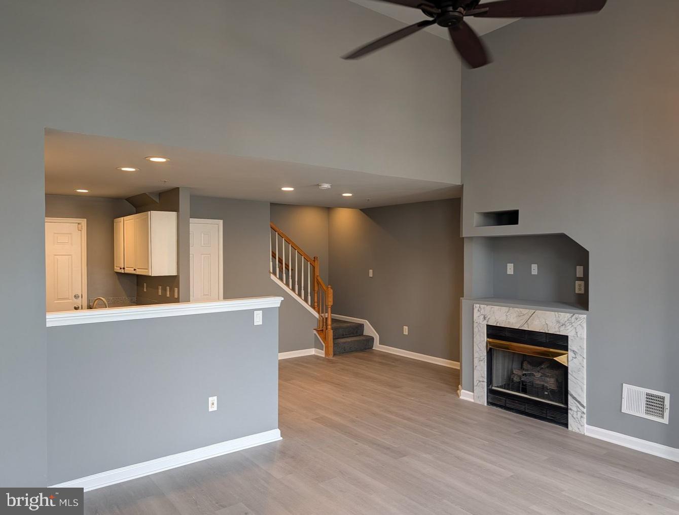 1891 Crescent Park Drive, Unit 110A Reston, VA 20190 - Photo 5 of 41 a view of a living room a fireplace with wooden floor