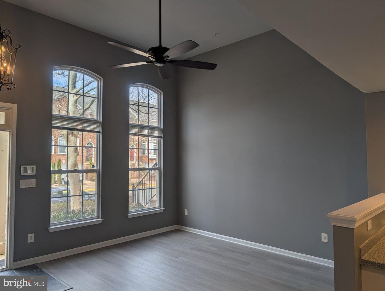 1891 Crescent Park Drive, Unit 110A Reston, VA 20190 - Photo 6 of 41 a view of an empty room with a window and wooden floor