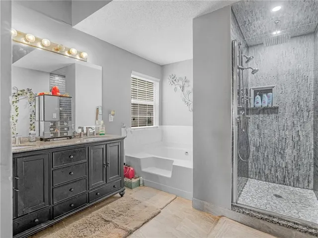 a bathroom with a shower sink and mirror