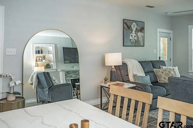 a kitchen with granite countertop white cabinets white appliances and a sink