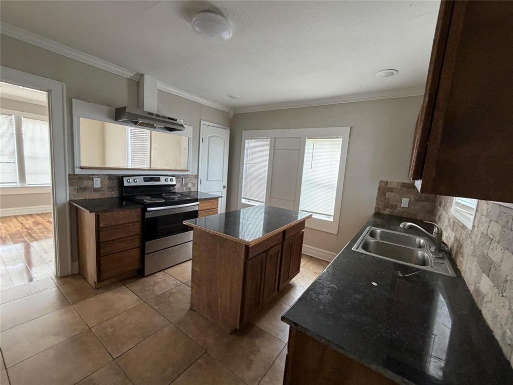 2240 Pin Oak Circle Haughton, LA 71037 - Photo 3 of 9 Kitchen with decorative backsplash, dark countertops, electric stove, crown molding, and a kitchen island