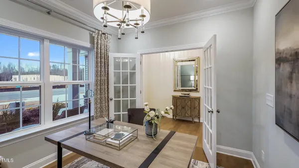 a living room with furniture and a chandelier