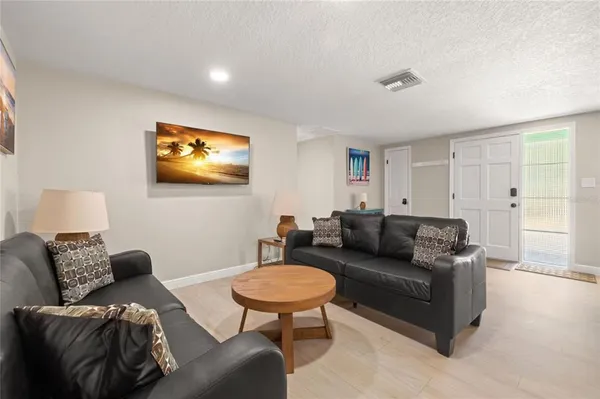 a living room with furniture and a lamp
