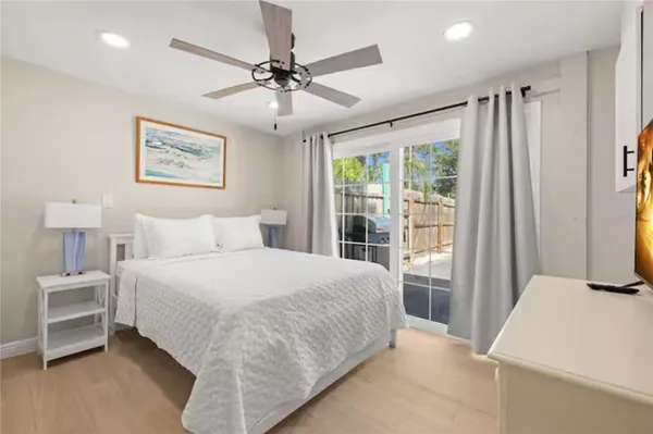 a bedroom with a large bed and a chandelier