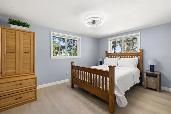 a bedroom with a bed lamp and a window