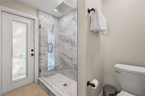 a bathroom with a shower a toilet and a sink