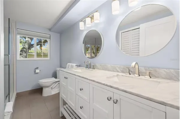 a bathroom with 2 sink and a mirror