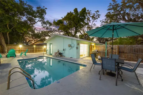 a swimming pool with outdoor seating yard and patio