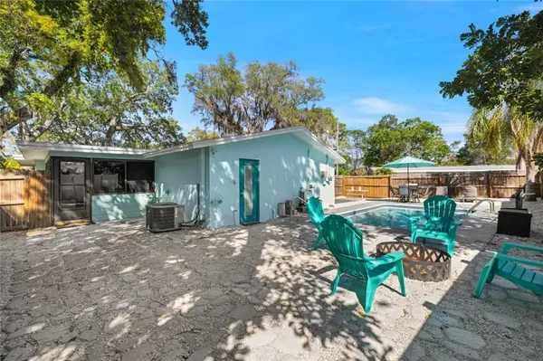 a view of a chair and tables in the patio