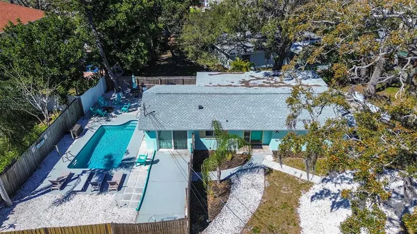 a view of a house with a yard and sitting area
