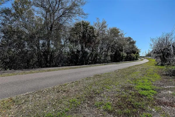 a view of street with a building and trees in the background