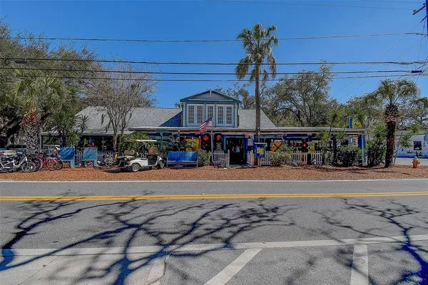 a street sign on a sidewalk next to a road