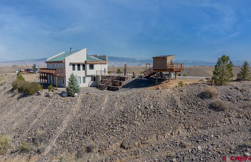 a view of a dry yard with wooden fence