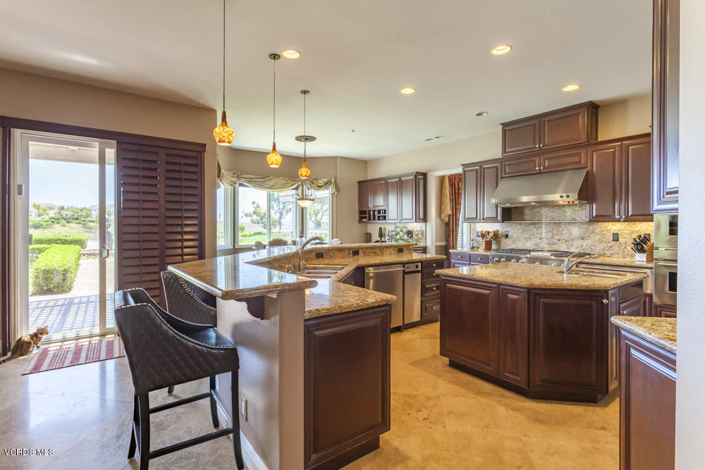 12054 Nelson Road Moorpark, CA 93021 - Photo 17 of 75 a kitchen with stainless steel appliances granite countertop a stove a sink a oven a dining table and chairs