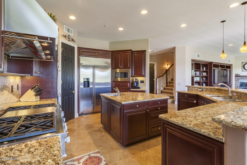 12054 Nelson Road Moorpark, CA 93021 - Photo 18 of 75 a kitchen with kitchen island granite countertop wooden cabinets and a stove