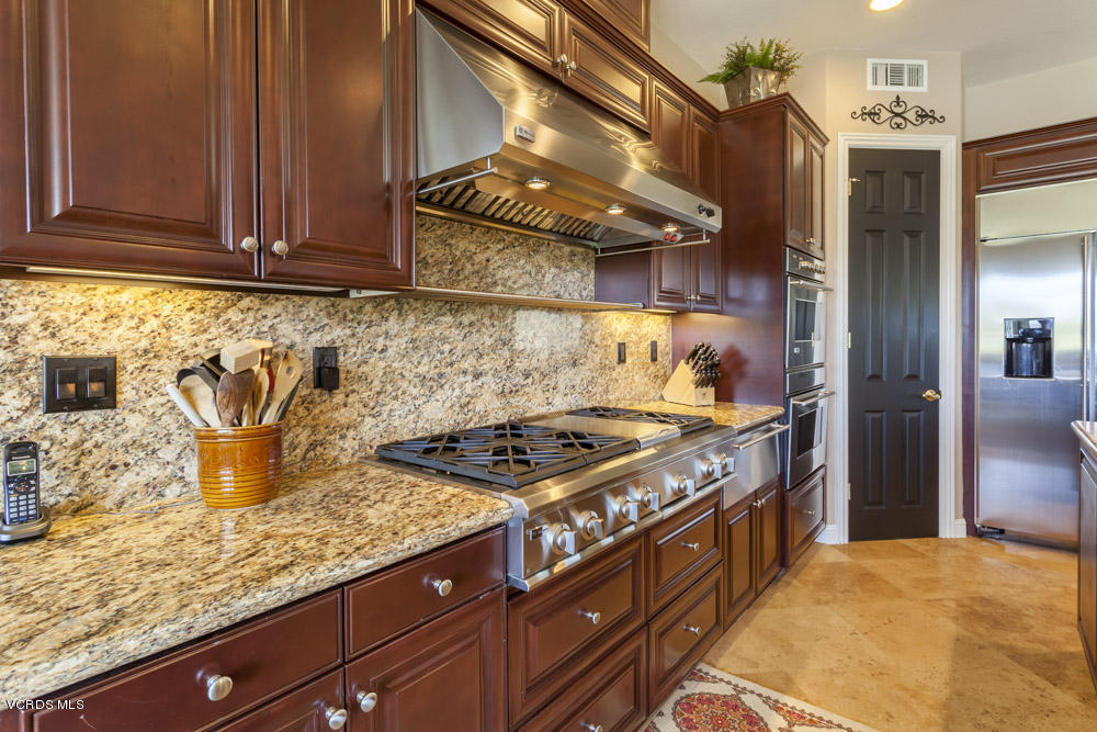 12054 Nelson Road Moorpark, CA 93021 - Photo 19 of 75 a kitchen with stainless steel appliances granite countertop a stove and a wooden cabinets