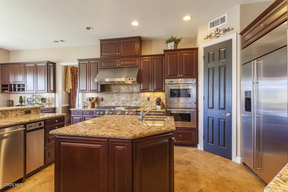 12054 Nelson Road Moorpark, CA 93021 - Photo 20 of 75 a kitchen with a refrigerator a sink and wooden cabinets