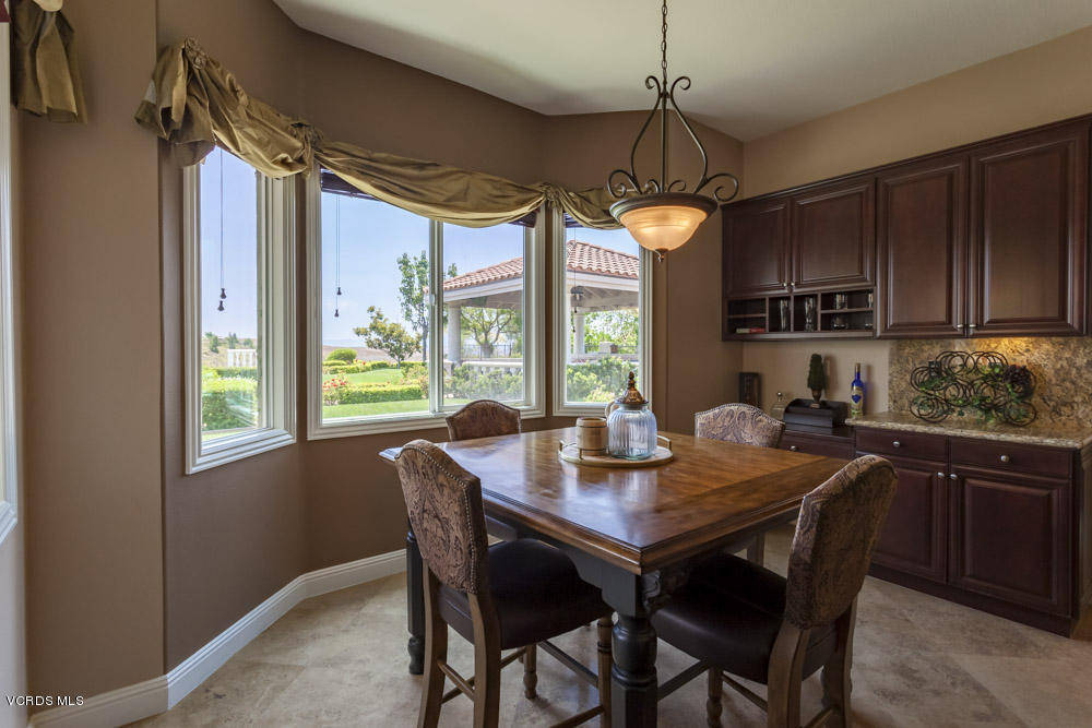 12054 Nelson Road Moorpark, CA 93021 - Photo 24 of 75 a dining room with wooden floor a chandelier a wooden table and chairs