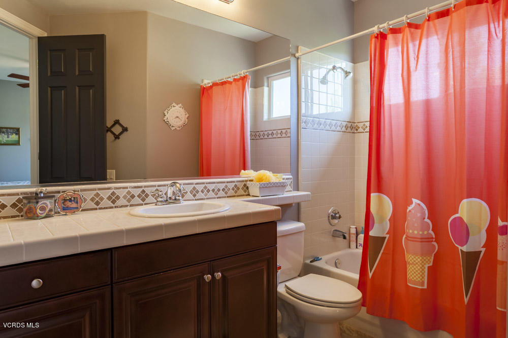 12054 Nelson Road Moorpark, CA 93021 - Photo 44 of 75 a bathroom with a sink a toilet and shower curtain