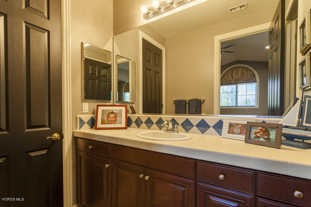 12054 Nelson Road Moorpark, CA 93021 - Photo 47 of 75 a bathroom with a sink and two mirror