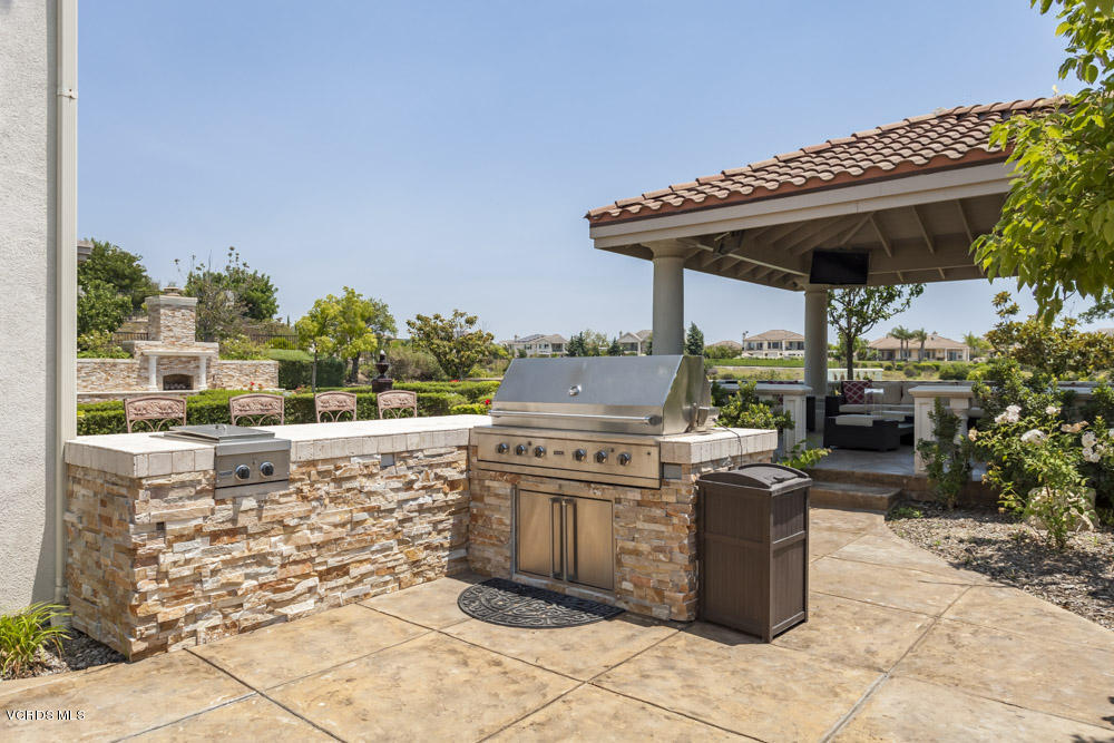 12054 Nelson Road Moorpark, CA 93021 - Photo 57 of 75 a view of a patio with table and chairs a barbeque