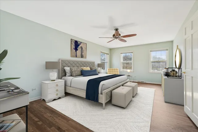 a spacious bedroom with a bed and a chandelier