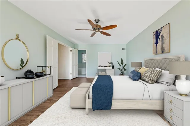 a bedroom with a large bed and a chandelier