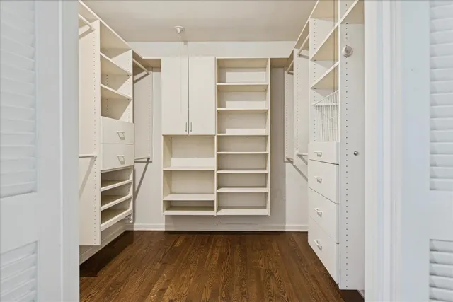 a view of walk in closet with empty racks
