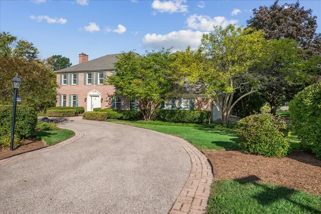 a front view of a house with a yard and a street