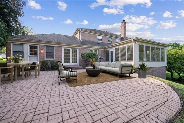 a view of a house with backyard and sitting area