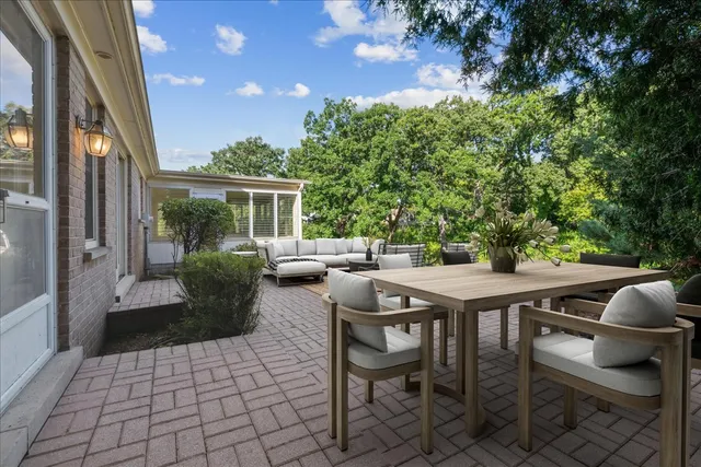 a view of a patio with table and chairs and potted plants