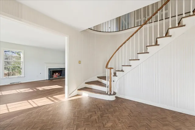 a view of entryway and hall with wooden floor