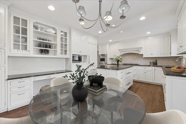 a living room with furniture chandelier and kitchen view