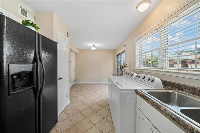 a kitchen with stainless steel appliances granite countertop a refrigerator and a sink