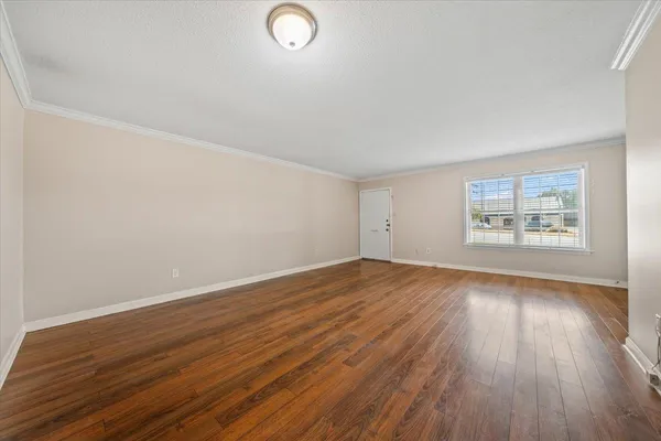 wooden floor in an empty room with a window