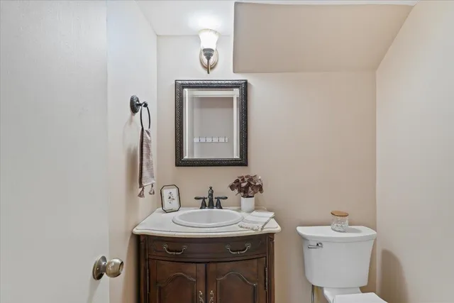 a bathroom with a sink a toilet and mirror