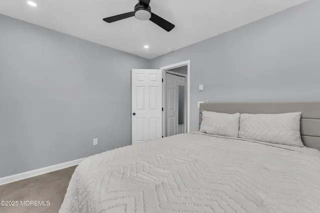 a large bed in a white room