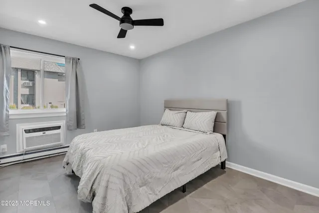 a bedroom with a bed and a ceiling fan