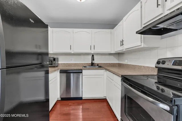a kitchen with a white cabinets and white appliances