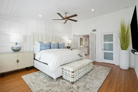 a bedroom with a bed and a flat screen tv