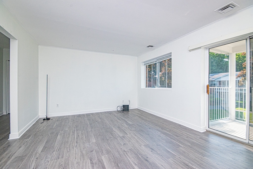 41 Bayberry Drive, Unit 4 Sharon, MA 02067 - Photo 11 of 27 an empty room with wooden floor and windows