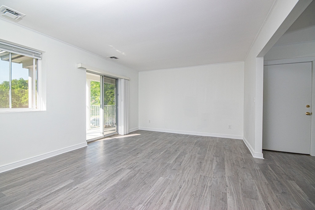 41 Bayberry Drive, Unit 4 Sharon, MA 02067 - Photo 12 of 27 an empty room with wooden floor and windows