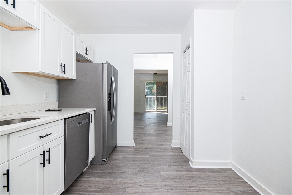41 Bayberry Drive, Unit 4 Sharon, MA 02067 - Photo 16 of 27 a kitchen with stainless steel appliances a refrigerator and cabinets