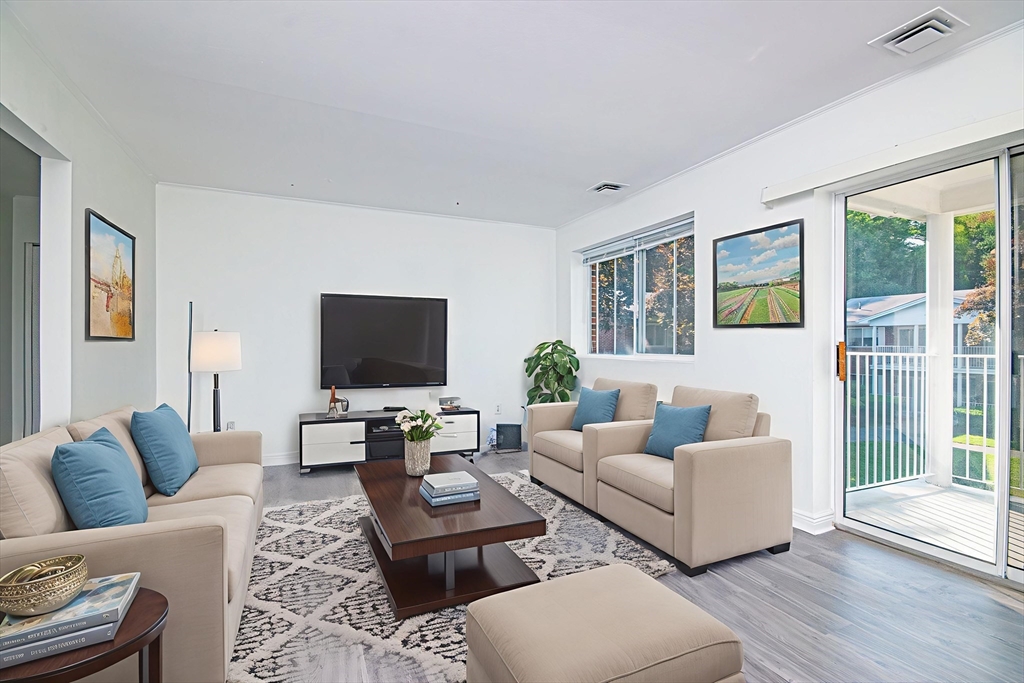 41 Bayberry Drive, Unit 4 Sharon, MA 02067 - Photo 2 of 27 a living room with furniture and a flat screen tv