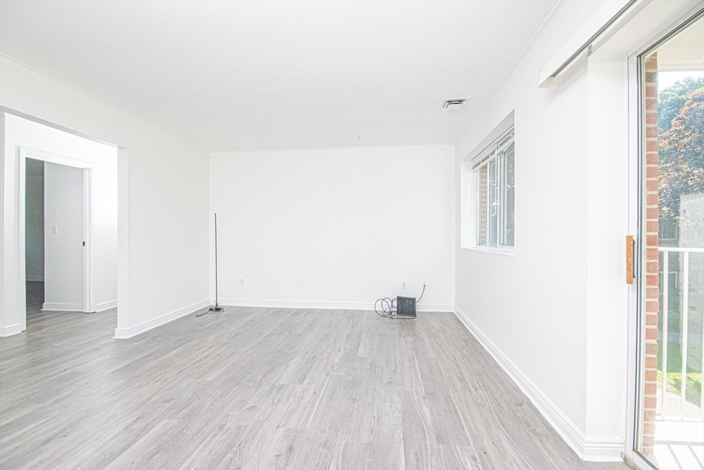 41 Bayberry Drive, Unit 4 Sharon, MA 02067 - Photo 7 of 27 an empty room with wooden floor and windows