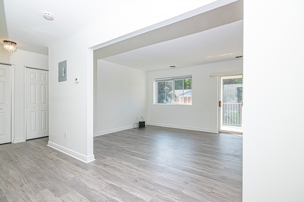 41 Bayberry Drive, Unit 4 Sharon, MA 02067 - Photo 9 of 27 an empty room with wooden floor and windows