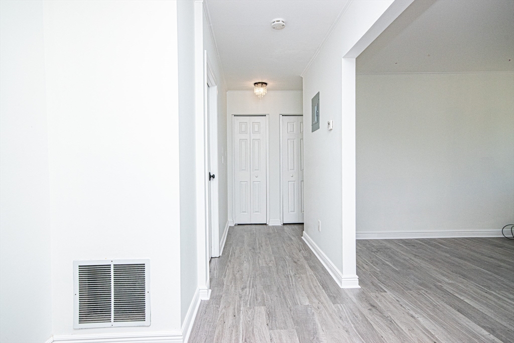 41 Bayberry Drive, Unit 4 Sharon, MA 02067 - Photo 10 of 27 a view of a hallway with wooden floor and a bathroom